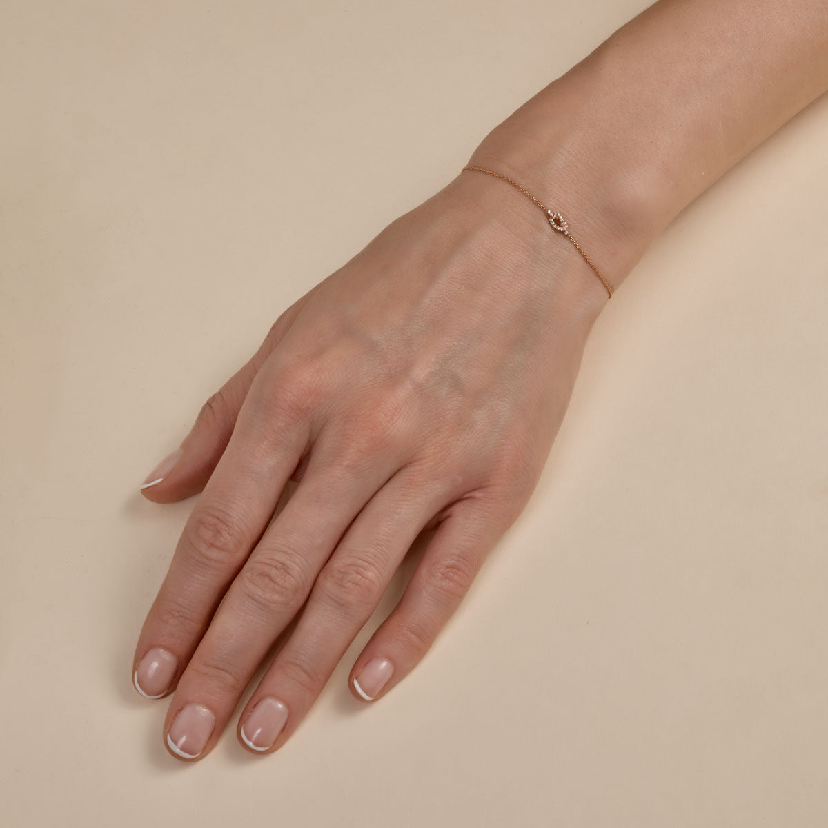 white diamond love knot bracelet on womans hand