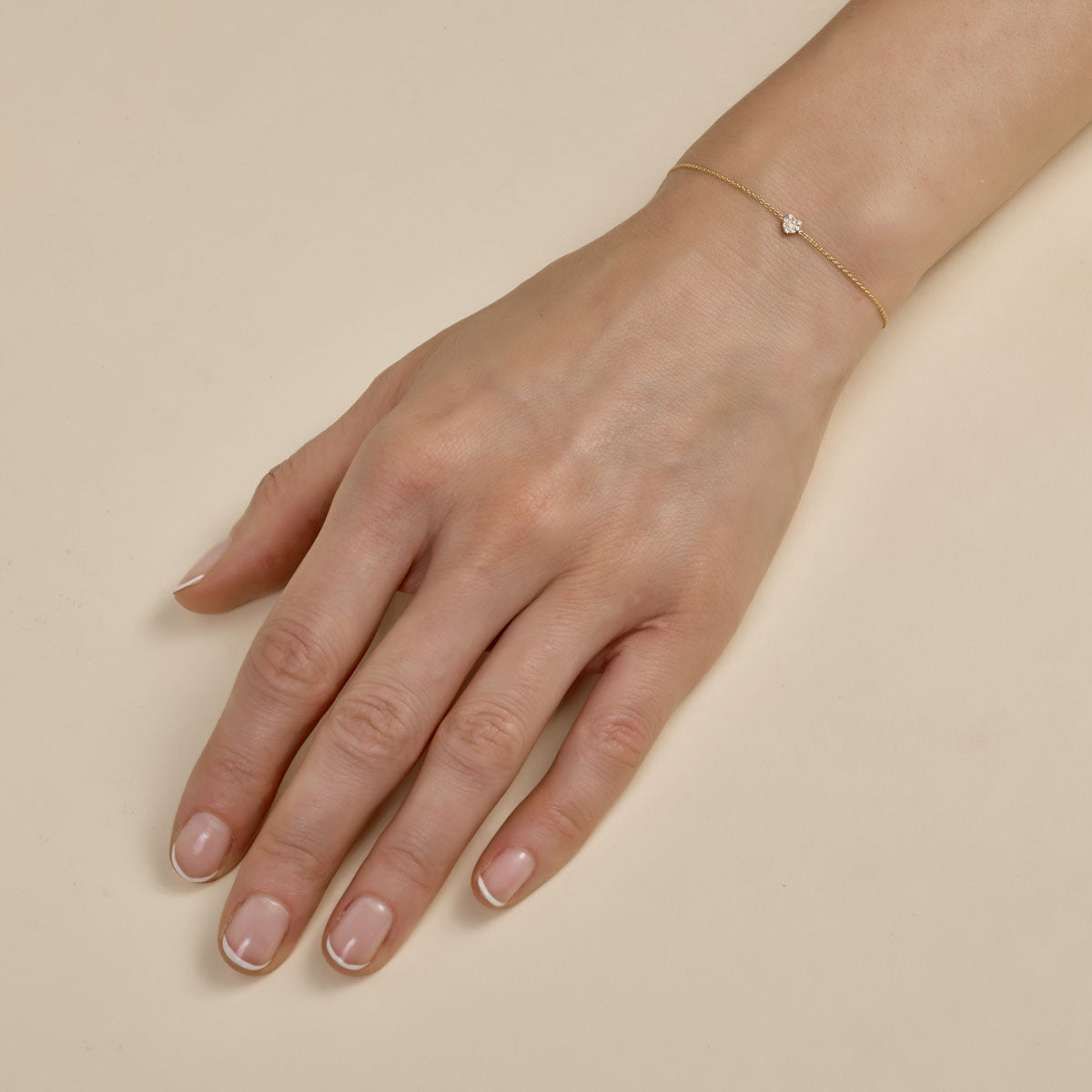 white diamond tiny heart bracelet on womans hand